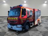 a red fire truck that is parked in a room