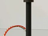 a small device that is connected to a red wire