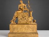 l'image d'une horloge en or sur laquelle est assise une femme