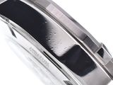 a close up of a watch on a white surface