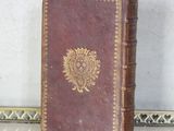 a brown book sitting on top of a table next to a mirror