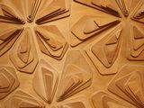 a close up of a wall that has many pieces of paper on it
