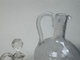 a glass vase and a glass figurine sitting on a table