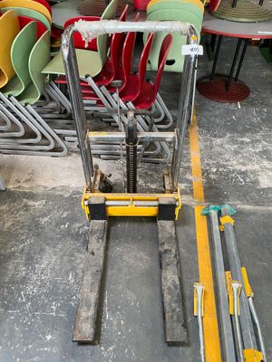 a fork lifter that is sitting in the middle of a room