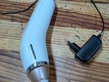 a hair dryer that is sitting on a wooden floor