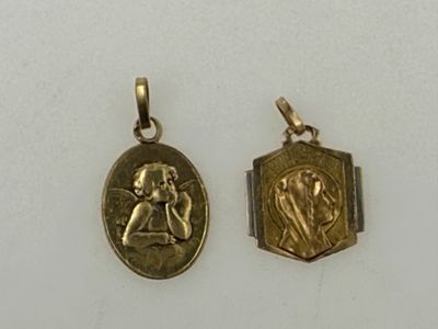 two gold lockes with an image of a man and a woman on them