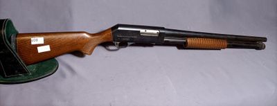 the gun is sitting on the table next to the hat