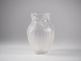 a clear glass vase with a swirly design on it