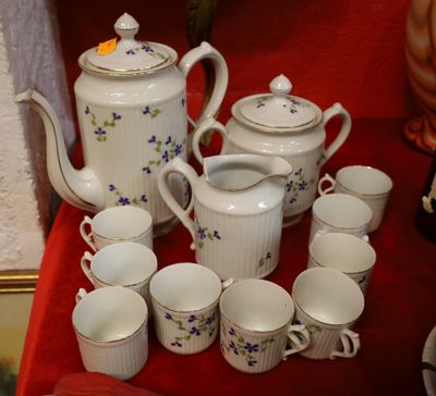 many cups and teapots sitting on a red table