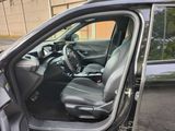 the interior of a car with the door open and the driver ' s seat down