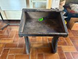 a small wooden table with a green object in it