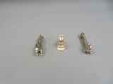 three pieces of silver metal on a white surface