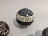 three marble balls sitting next to each other on a table