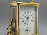 an image of a gold clock with a key on top of it