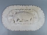 a white sculpture of a sheep and a bird on the wall