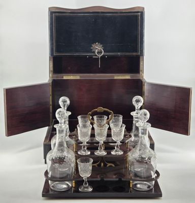 a wooden box with a set of wine glasses on it
