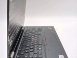 a black laptop with a red button on the keyboard
