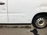 a white van parked in a parking lot next to a fire hydrant