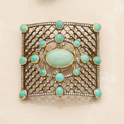 turquoise and diamond broochle set on a white background