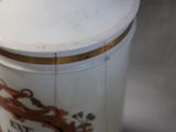 a close up of a vase with a bird on it