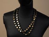 a close up of a mannequin torso with a necklace on it