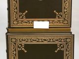 two black and gold boxes with a lion head on the front