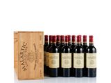 six bottles of wine in a wooden box with a wooden box behind them