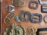 a wooden box with many different types of belts and buckles