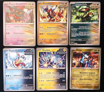 a lot of different pokemon cards on the table