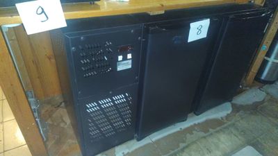 two black refrigerators sitting next to each other on a counter