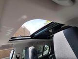a view of the sunroof from inside of a car