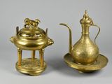 pair of antique brass teapots and saucer on stand