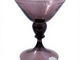 purple glass bowl on pedestal on white background with white background