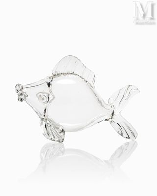 clear glass fish figurine on white background with reflection