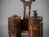 pair of carved wooden side tables with a bird on top of them