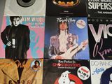 a lot of records on a table with a vinyl record on it