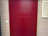 a red roller up door in a storage unit