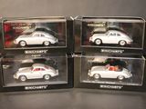 three boxed boxed white porsches in boxes on a table