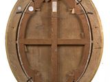 a round wooden window with a cross on it