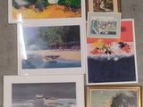 a lot of pictures hanging on the wall next to each other