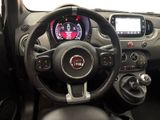 the interior of a small car with a steering wheel and dashboard controls