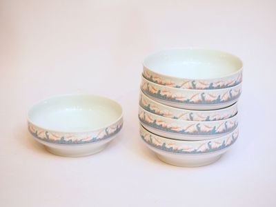 four bowls that are sitting on a white surface