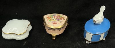 three different types of porcelain items are displayed on a black surface
