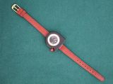 an image of a wrist watch sitting on a green surface