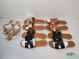 four pairs of sandals and a plate of food on a table