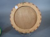 a picture of a wooden plate on a stand
