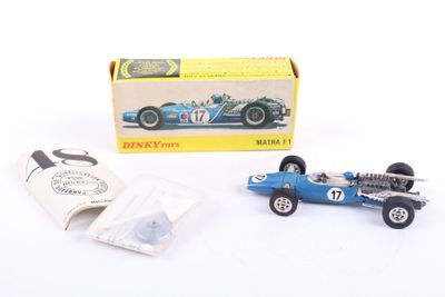 a small blue race car in front of a box