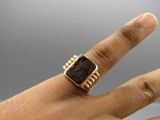 an image of a person ' s hand with a ring on it