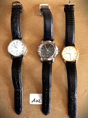 three different types of watches sitting on top of a brown surface