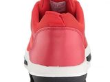 a close up of a pair of red sneakers on a white background